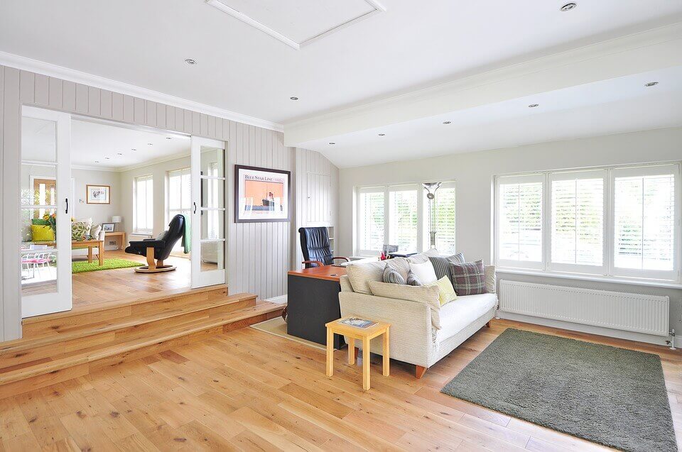 Steps leading down into living space with oak hardwood floors