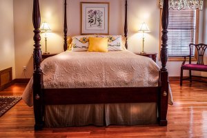 Four post bed on Cherry hardwood floor