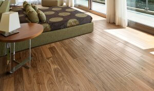 Bedroom with a low bed on walnut hardwood flooring